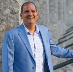 President and Vice-Chancellor wearing a blue suit jacket