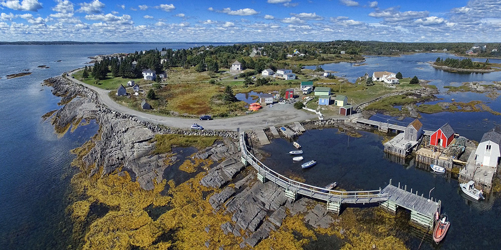 An aerial shot of the community of Blue Rocks, showing its rugged coastline and fishing buildings.