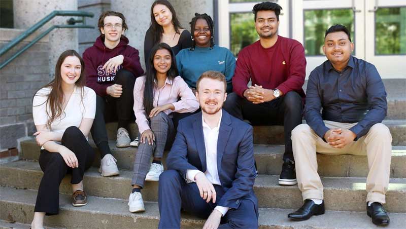 A group of Sobey students sitting on steps.